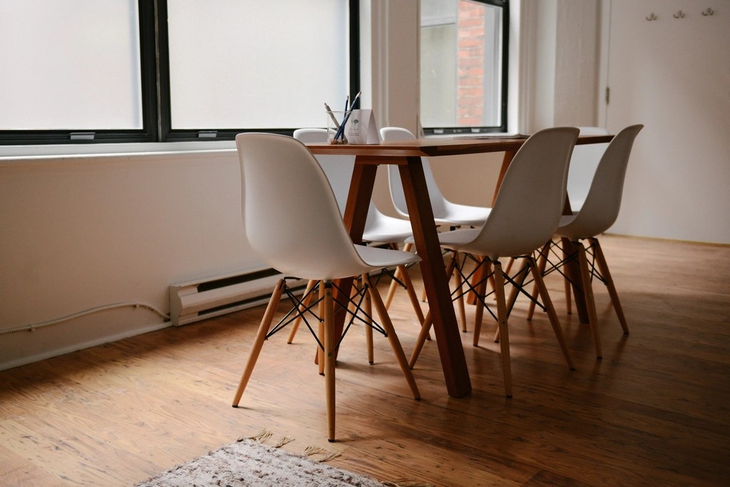 A bright meeting room with a table and chairs